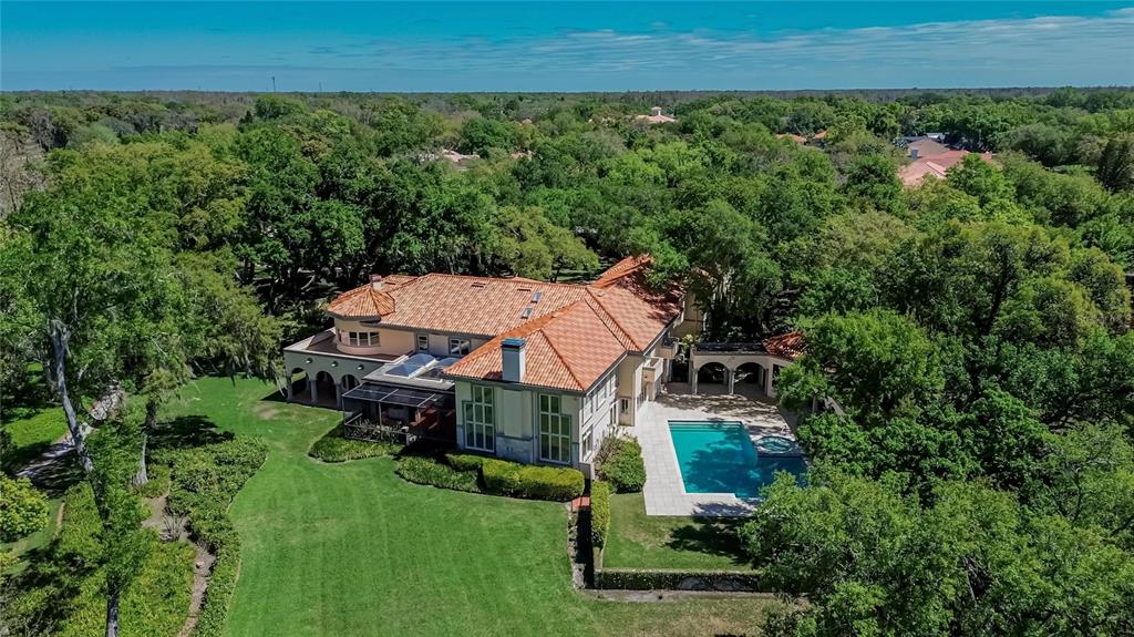 An aerial view of a large house with a terracotta roof and a swimming pool — 1043 GUISANDO DE AVILA, TAMPA, FL