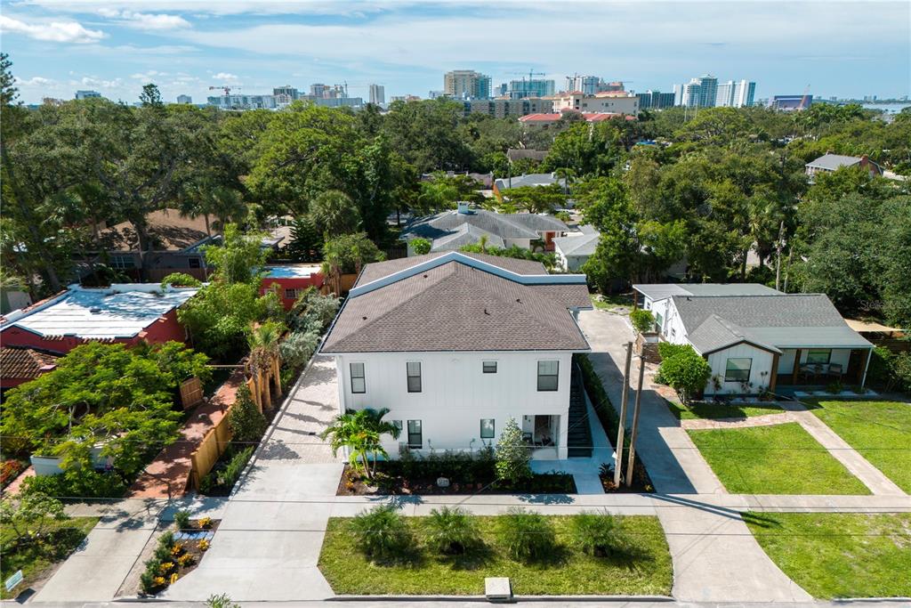 An aerial view shows a two-story white house with a dark roof and surrounding landscaping — 1234 15TH STREET UNIT 201, SARASOTA, FL