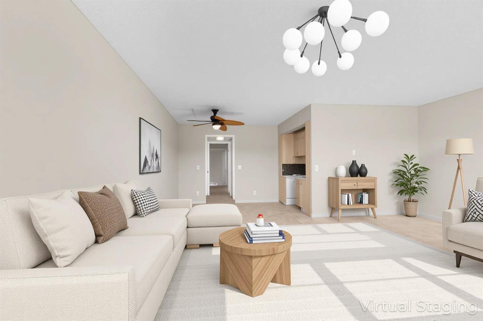 This is a virtually staged living room featuring a sectional sofa, coffee table, and chandelier — 3013 Wolverton A, Boca Raton FL 33434, BOCA RATON, FL