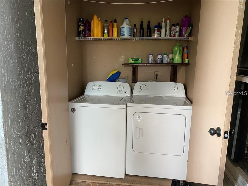 A laundry closet contains a white top-loading washing machine and a white dryer — 2404 NORTHLAKE DRIVE NE UNIT 2404, SANFORD, FL