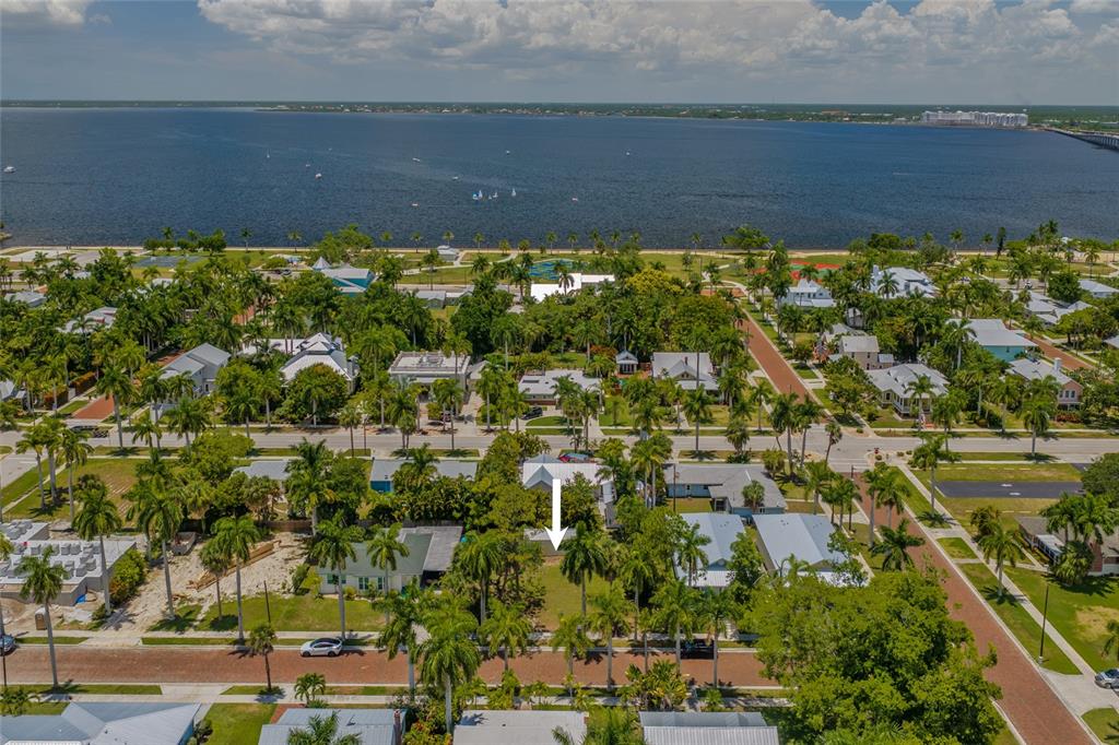 An aerial view shows a residential lot with palm trees near a large body of water — 610 TRABUE AVENUE, PUNTA GORDA, FL