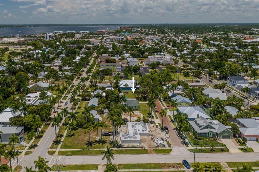 An aerial view shows a residential neighborhood with a construction site and a marked house — 610 TRABUE AVENUE, PUNTA GORDA, FL