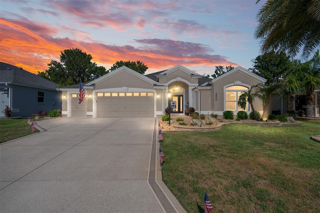 A single-story house with a beige stucco exterior, a three-car garage, and a concrete driveway — 3806 VIEW PATH, THE VILLAGES, FL