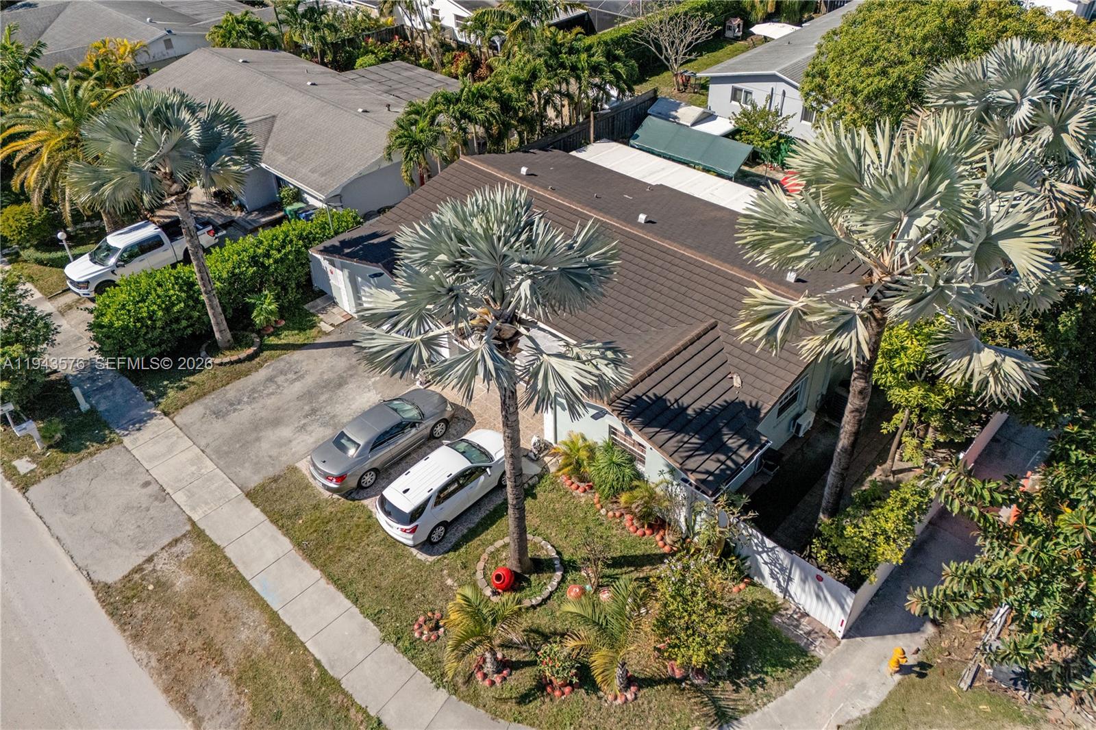 An aerial view shows a single-story house with a dark roof, palm trees, and cars — 20150 SW 89th Ct, Cutler Bay FL 33189, CUTLER BAY, FL