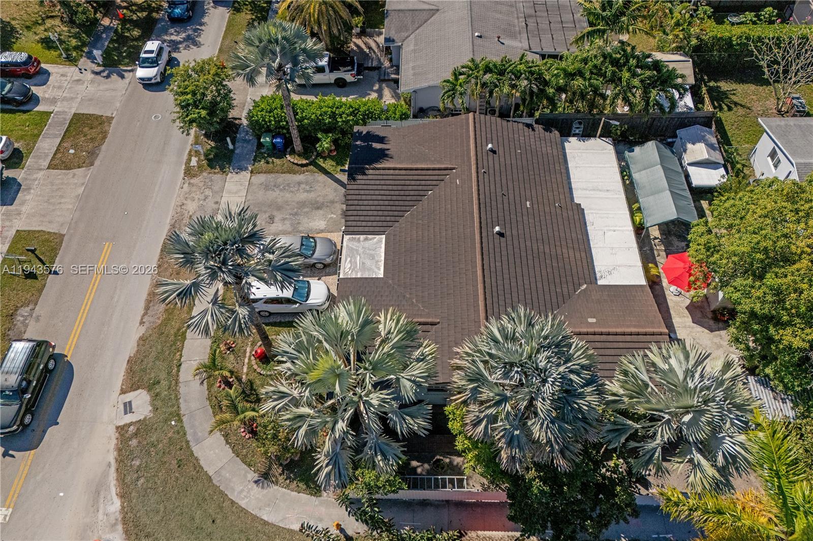 An aerial view shows a house with a dark tiled roof and palm trees — 20150 SW 89th Ct, Cutler Bay FL 33189, CUTLER BAY, FL