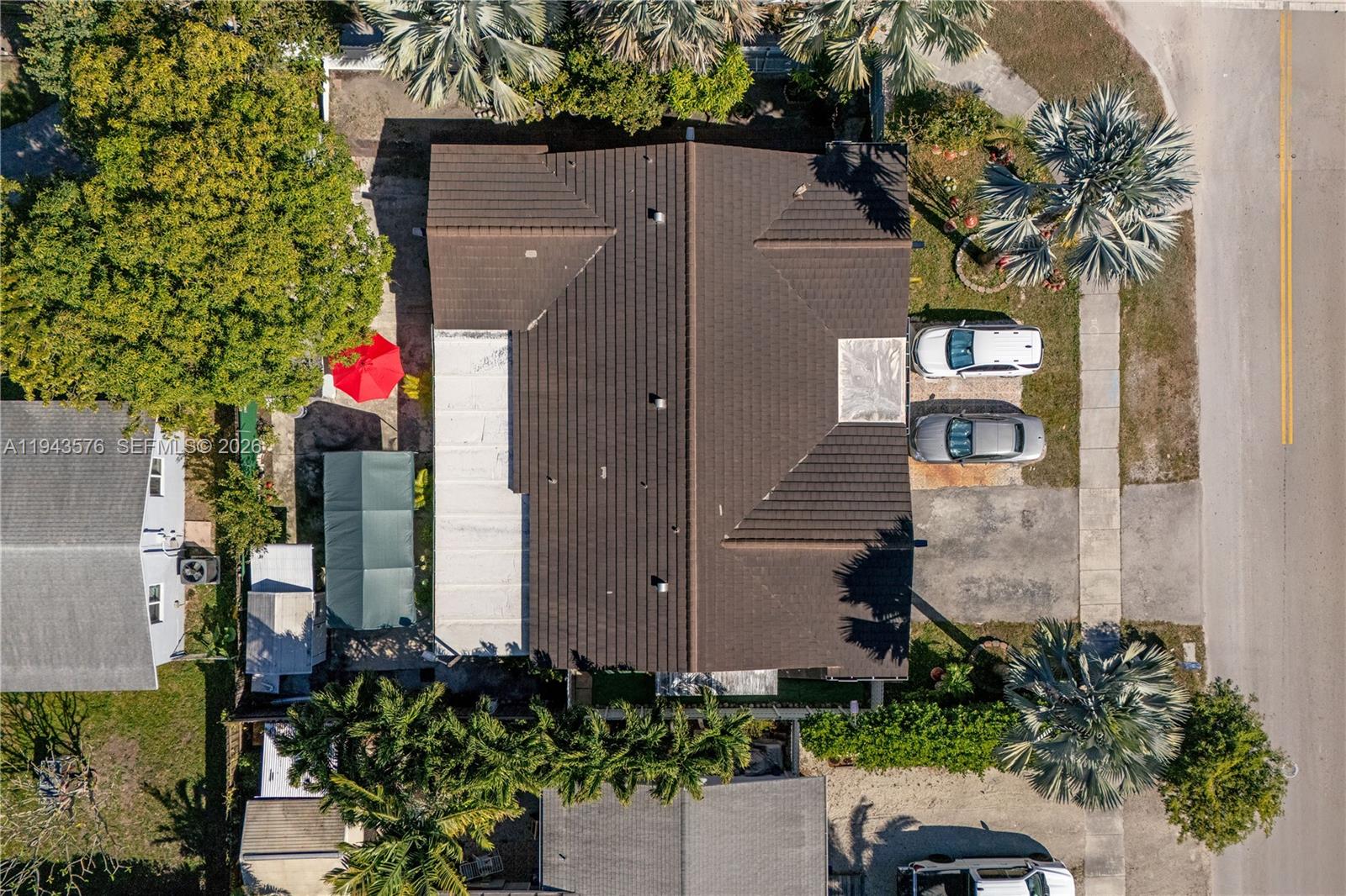 An aerial view shows a house with a dark tiled roof, a driveway, and landscaping — 20150 SW 89th Ct, Cutler Bay FL 33189, CUTLER BAY, FL