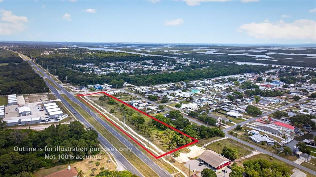 An aerial view shows a rectangular vacant lot outlined in red next to a highway — N US HWY 1, OAK HILL, FL