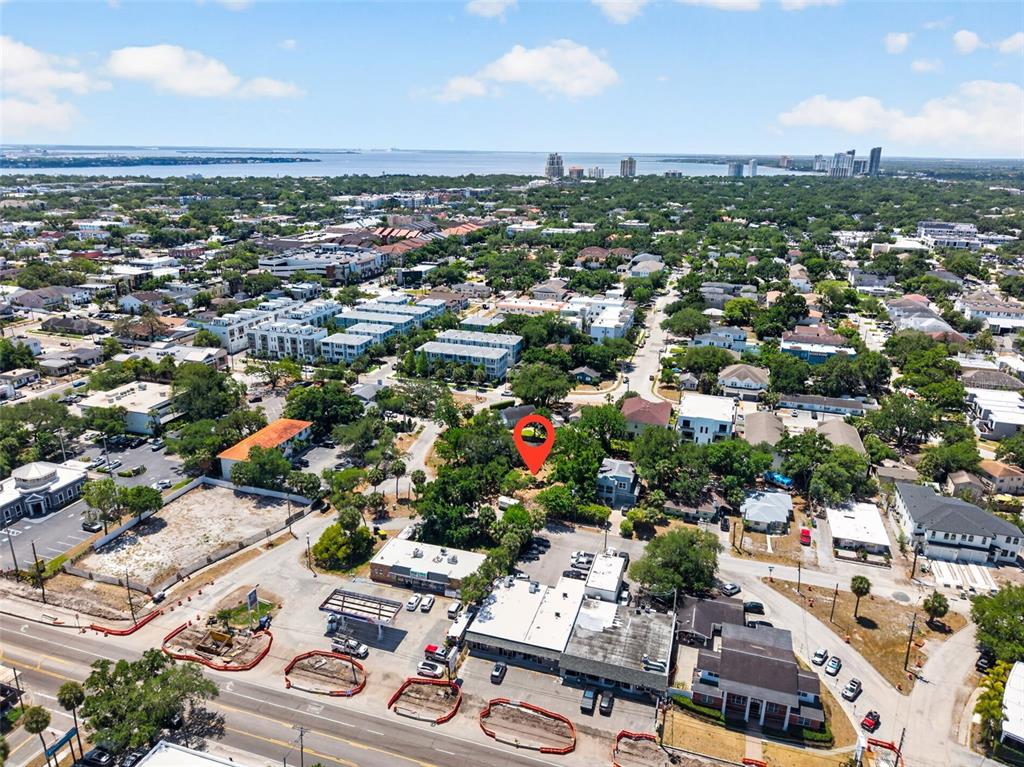 An aerial view shows a commercial area with a gas station and surrounding residential buildings — 2604 N CLEVELAND STREET, TAMPA, FL
