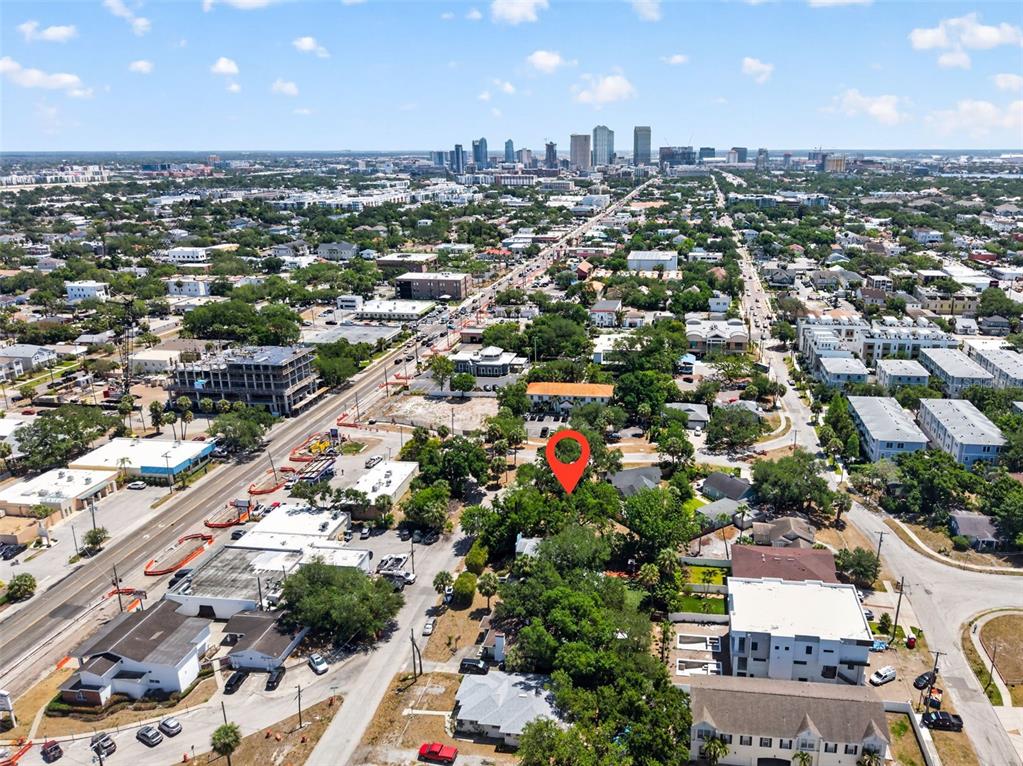 An aerial view shows a city skyline with a red location pin over trees — 2604 N CLEVELAND STREET, TAMPA, FL