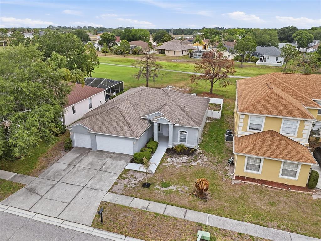 An aerial view shows a single-story gray house with a two-car garage and driveway — 11214 SAILBROOKE DRIVE, RIVERVIEW, FL