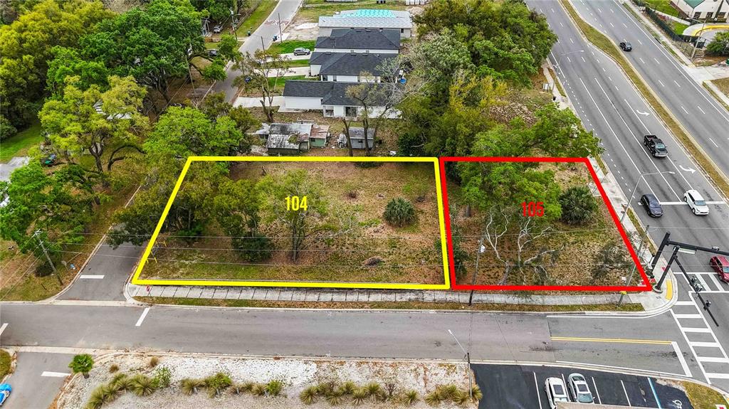 An aerial view shows two adjacent vacant lots outlined in yellow and red near a road — 104 N VAN BUREN AVENUE, ORLANDO, FL