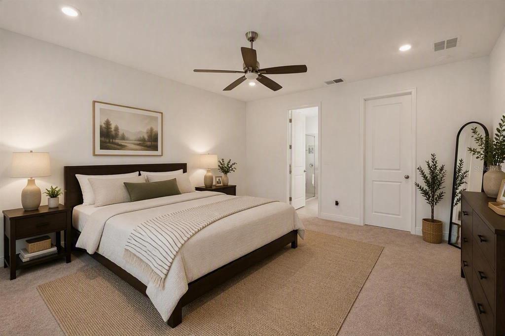 A bedroom features a bed with neutral bedding, a ceiling fan, and a wooden dresser — 1699 MEADOWLARK DRIVE, DELTONA, FL