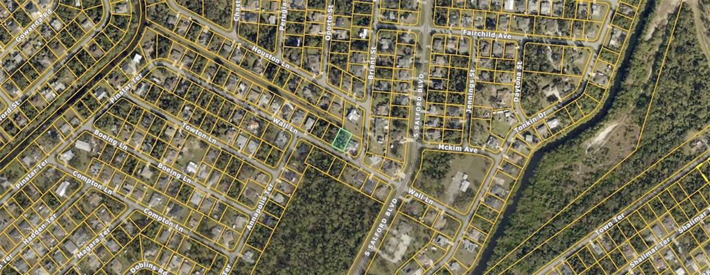 This is an aerial map view of a residential neighborhood with highlighted property boundaries — WALL LANE, NORTH PORT, FL