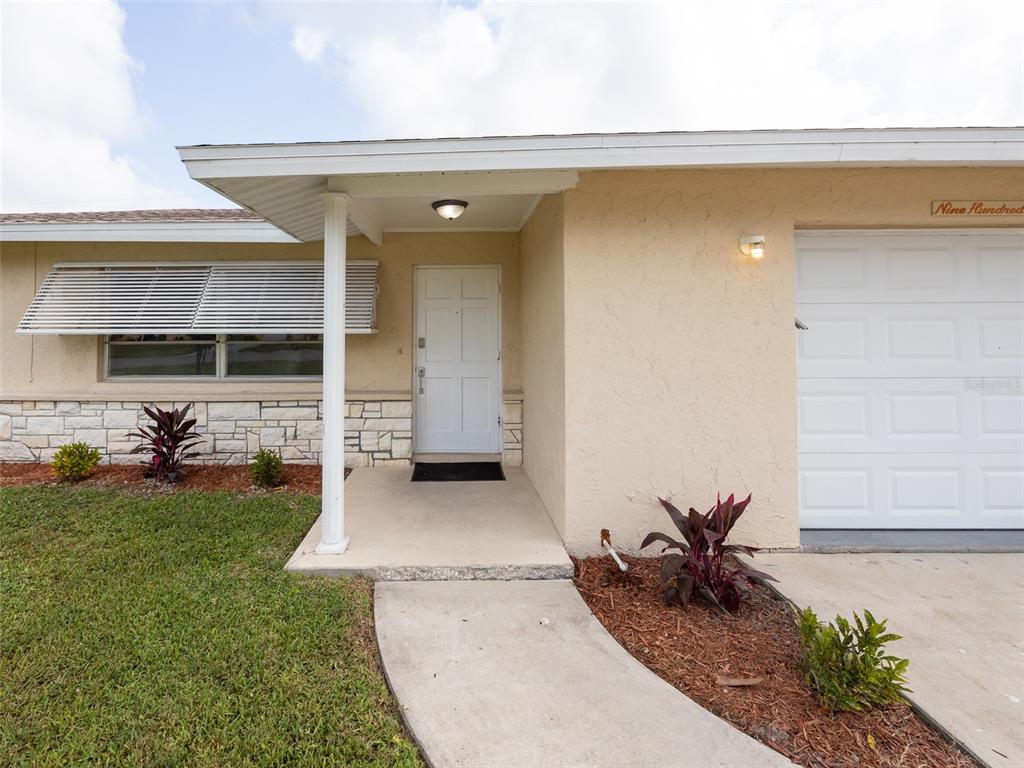 An aerial view of three suburban houses with driveways and lawns on a residential street — 916 GILLESPIE STREET, ENGLEWOOD, FL