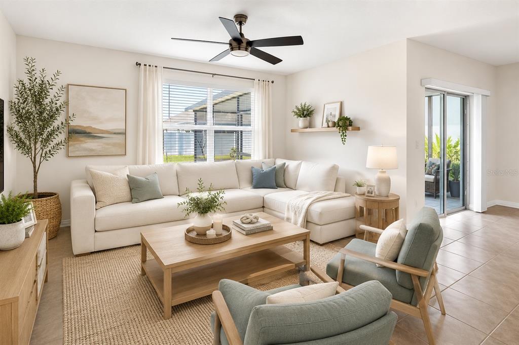 A bright living room features a large sectional sofa, two armchairs, and a coffee table — 1673 BARBERRY DRIVE, KISSIMMEE, FL