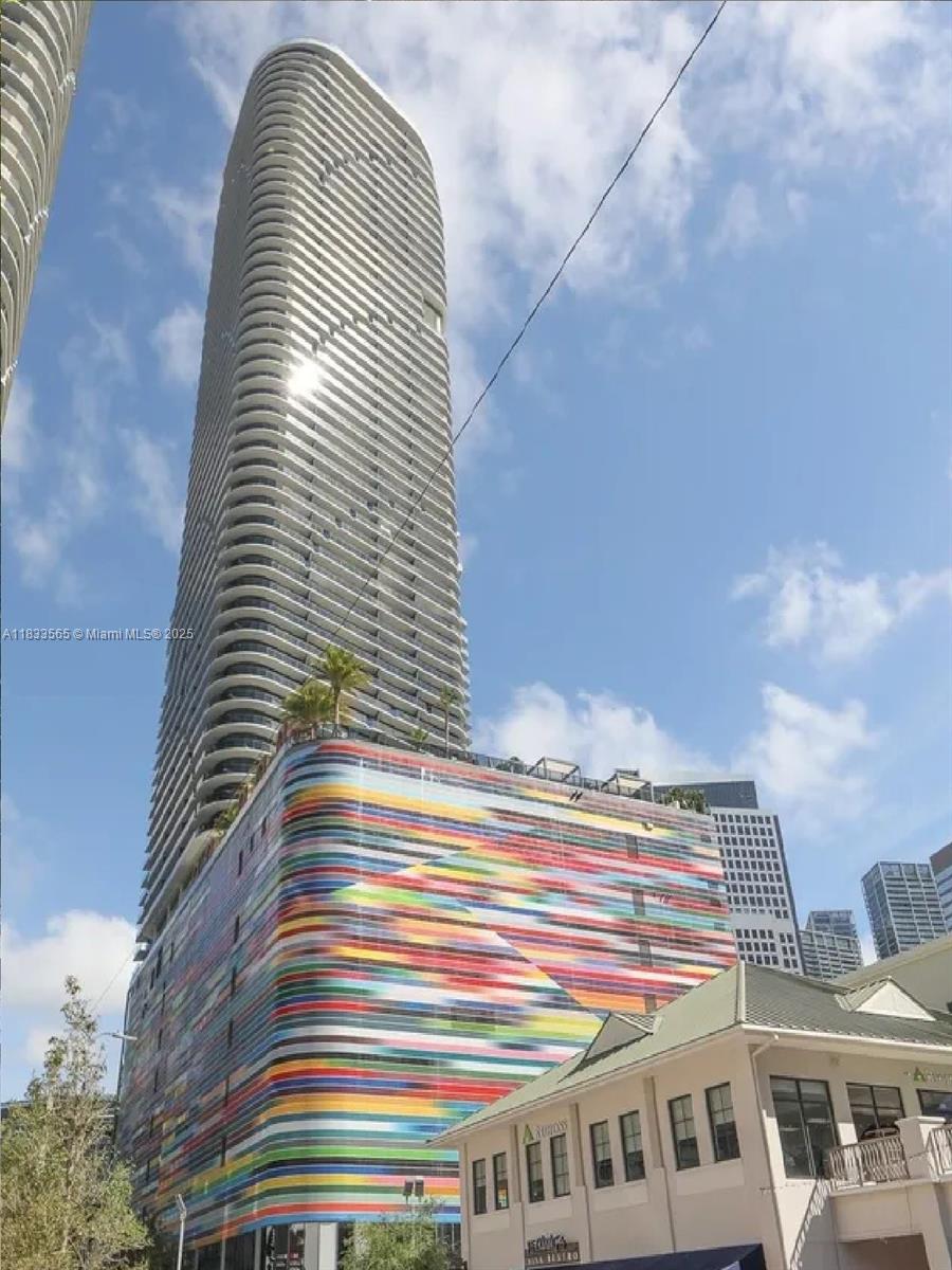 An elevated view of a dense urban skyline featuring numerous modern skyscrapers under a blue sky — 801 S Miami Ave # 4204, Miami FL 33130, MIAMI, FL