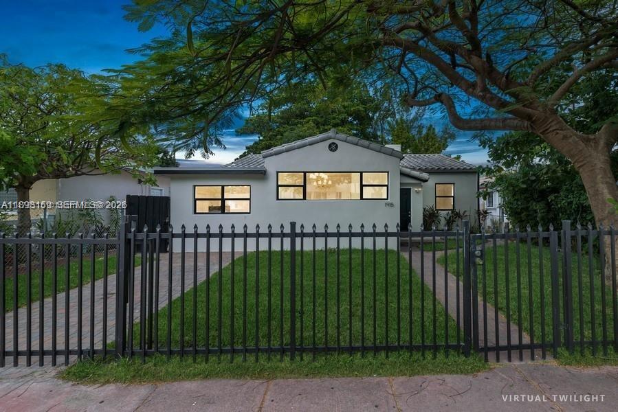 A single-story house with a white exterior, black-framed windows, and a black metal fence — 1915 Normandy Dr, Miami Beach FL 33141, MIAMI BEACH, FL