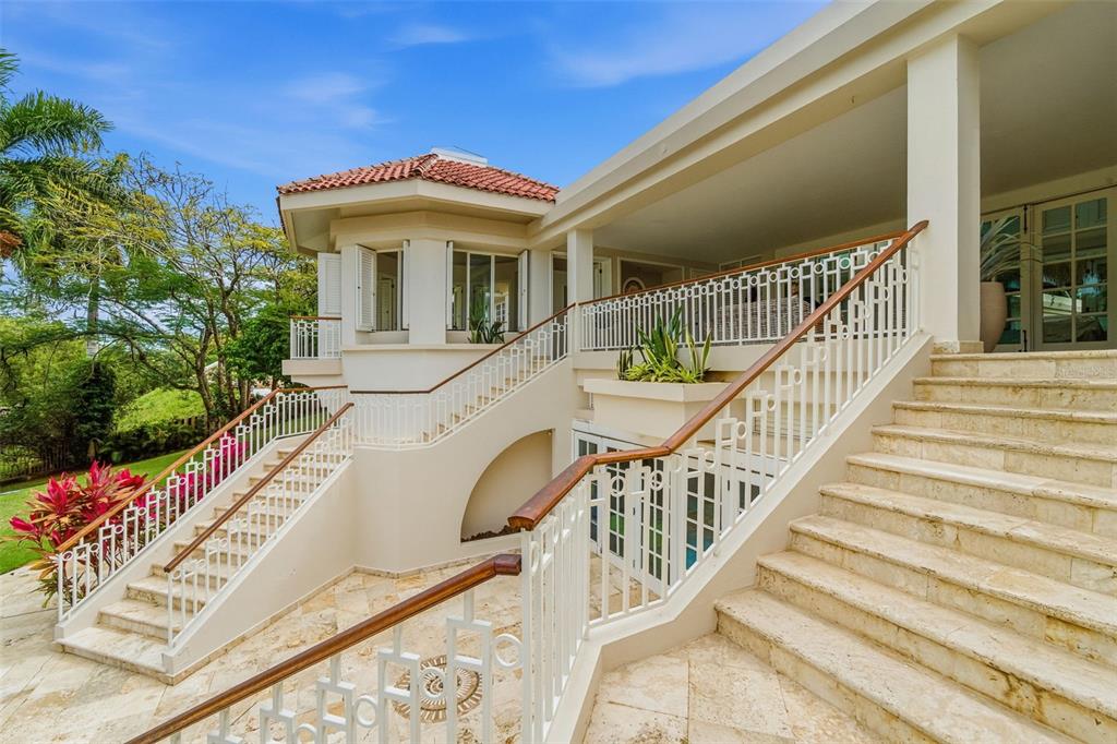 A stone staircase with white metal railings leads to a covered patio of a house — 15 DORADO BEACH ESTATES, DORADO, PR