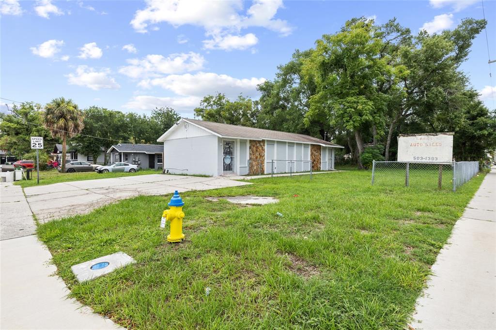 A single-story commercial building with a concrete lot and a fire hydrant in front — 3713 N 34TH STREET, TAMPA, FL