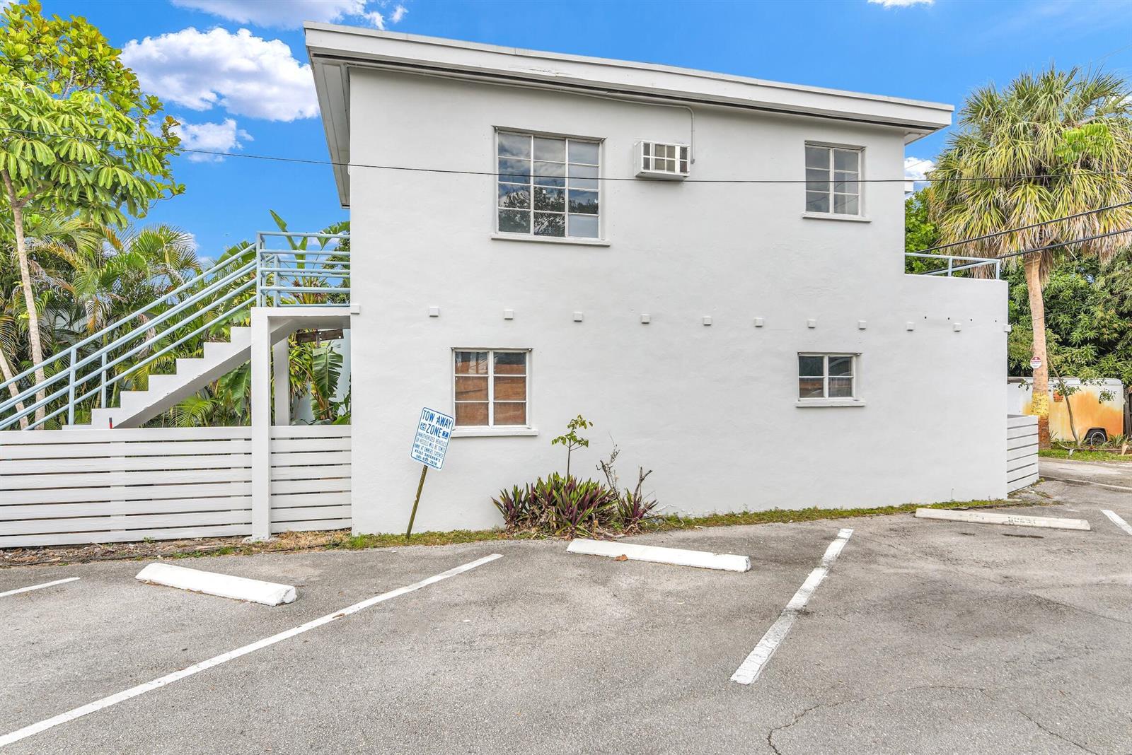 A two-story white building with an exterior staircase and a paved parking lot — 820 N Dixie Highway # 4, FL 33460, FL