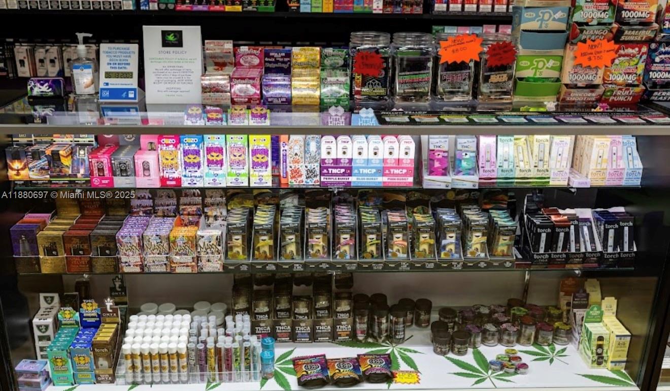 A retail display case is filled with various packaged vape and cannabis-related products — 16774 SW 88TH ST, Miami FL 33196, MIAMI, FL