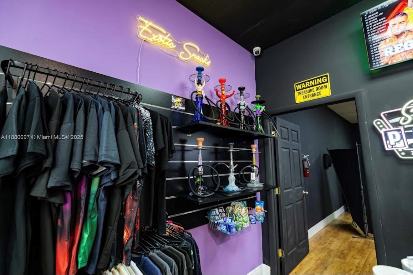 A retail space features clothing racks, hookah displays, a neon sign, and a treasure room entrance — 16774 SW 88TH ST, Miami FL 33196, MIAMI, FL