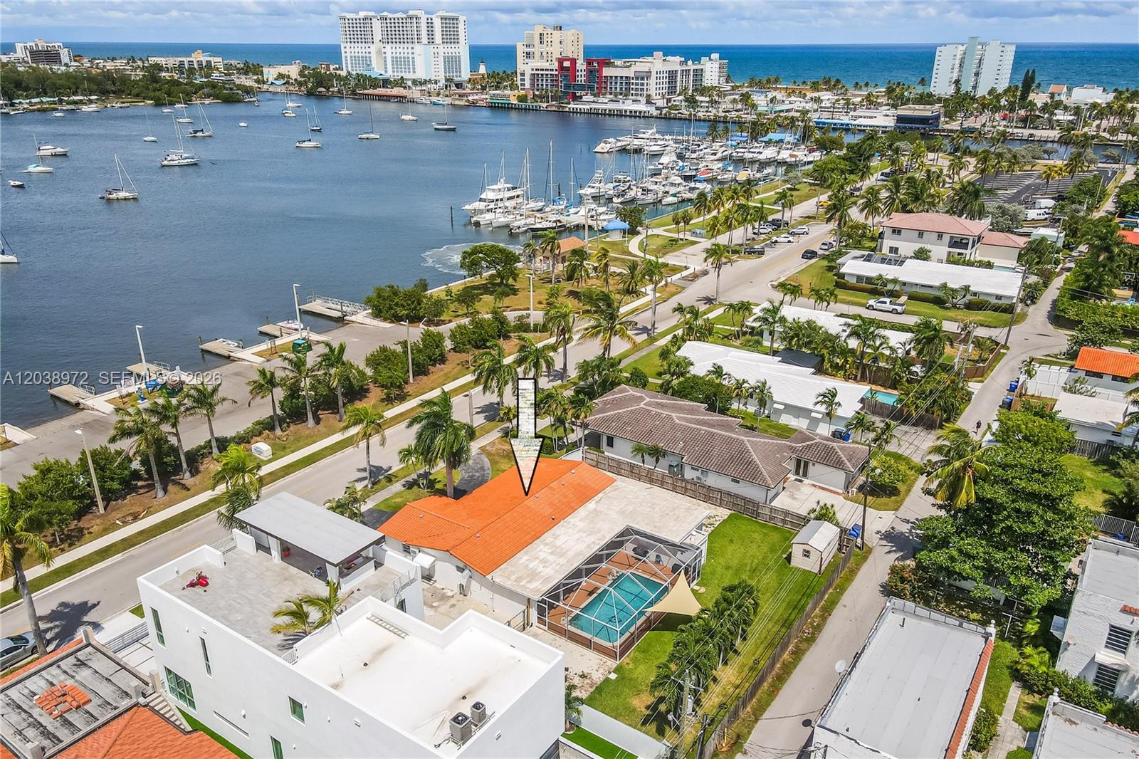 An aerial view shows a house with an orange roof and a screened-in swimming pool — 816 Polk St # 1, Hollywood FL 33019, HOLLYWOOD, FL