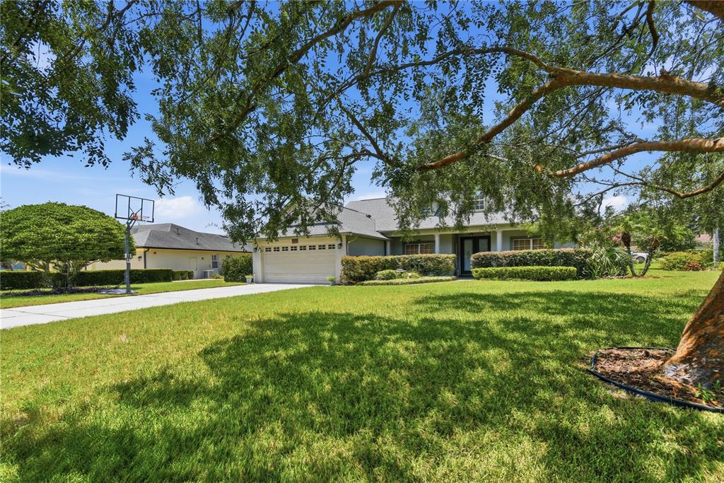 A single-story house with a two-car garage and a basketball hoop on the driveway — 23354 OAK PRAIRIE CIRCLE, SORRENTO, FL