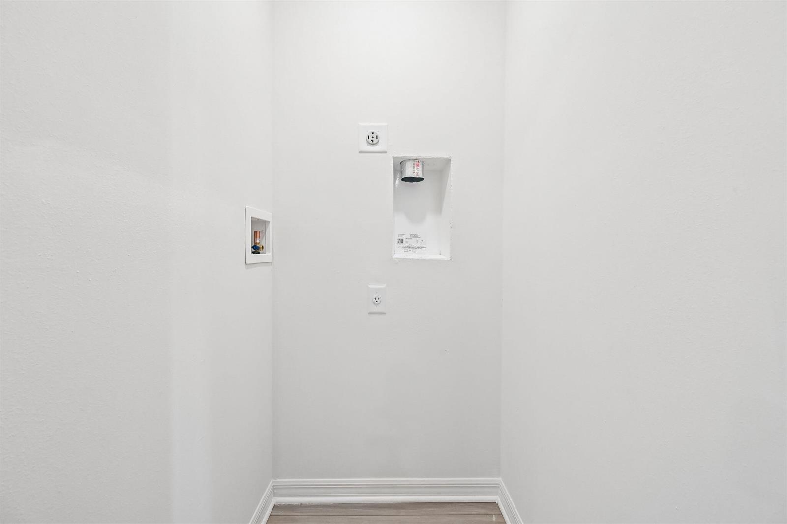 A laundry room alcove features white walls, a dryer vent, and plumbing hookups — 5717 Palm Drive, Fort Pierce FL 34982, FORT PIERCE, FL