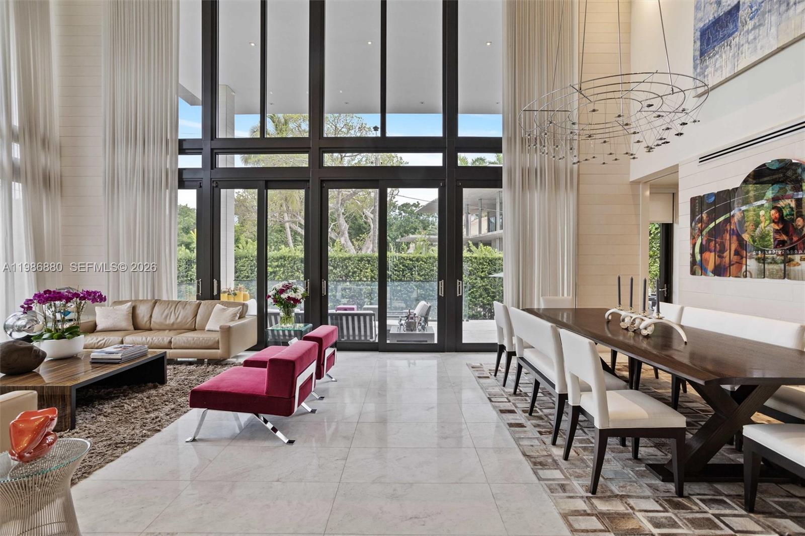 A spacious living and dining area features floor-to-ceiling windows, marble floors, and modern furniture — 610 Harbor Cir, Key Biscayne FL 33149, KEY BISCAYNE, FL