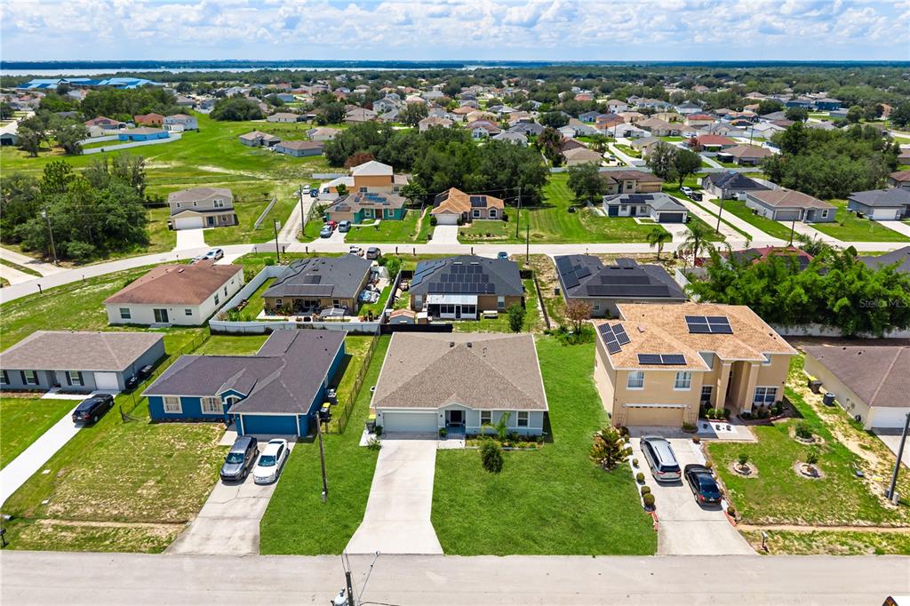 An aerial view shows a suburban neighborhood with several single-family homes and paved driveways — 1918 MICHIGAN DRIVE, KISSIMMEE, FL