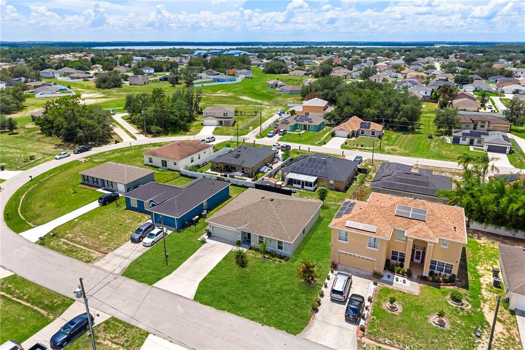 An aerial view shows a suburban neighborhood with several single-family homes and grassy lots — 1918 MICHIGAN DRIVE, KISSIMMEE, FL
