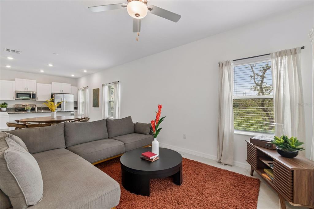 An entryway features a tiled floor, a black cabinet with rattan doors, and carpeted stairs — 873 TENNYSON MILL CIRCLE, TAMPA, FL