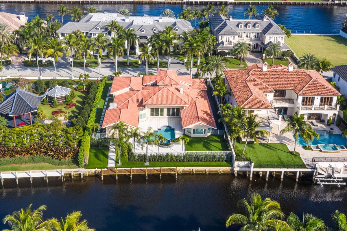 An aerial view shows two waterfront houses with red-tiled roofs, swimming pools, and private docks — 533 E Alexander Palm Road, Boca Raton FL 33432, BOCA RATON, FL