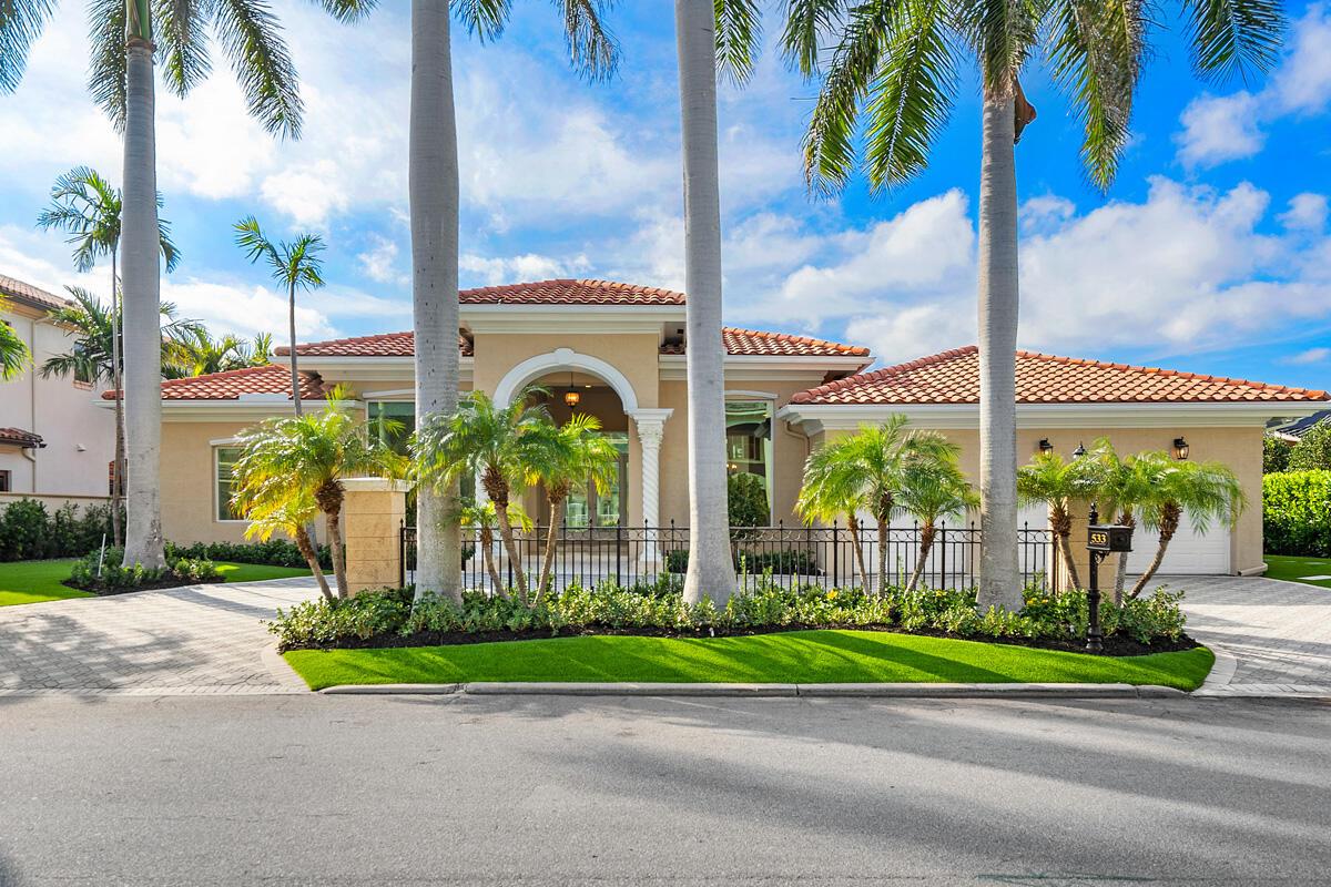 A single-story house with a tile roof, arched entryway, and palm trees in the front yard — 533 E Alexander Palm Road, Boca Raton FL 33432, BOCA RATON, FL