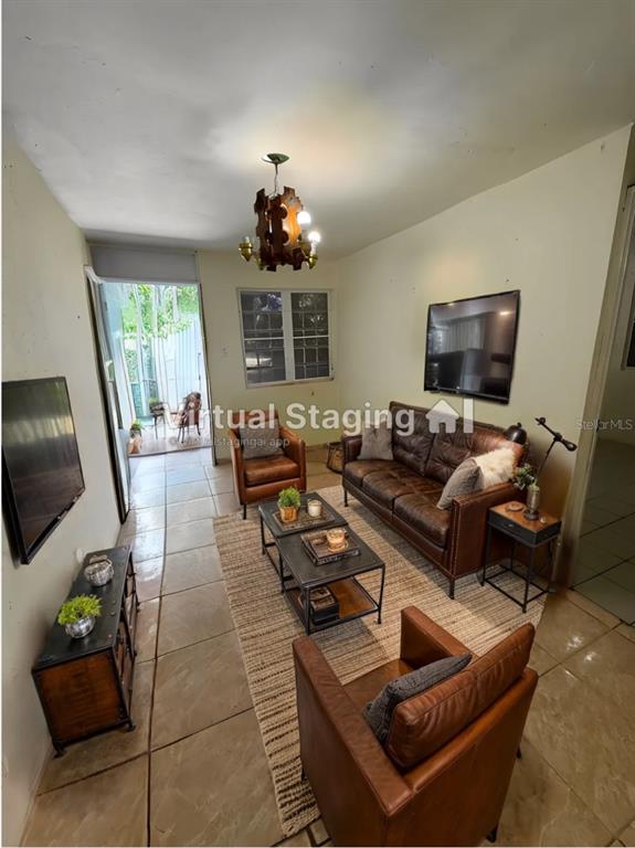 This living room features a leather sofa, two armchairs, a coffee table, and tile flooring — KM 5.0 906, YABUCOA, PR