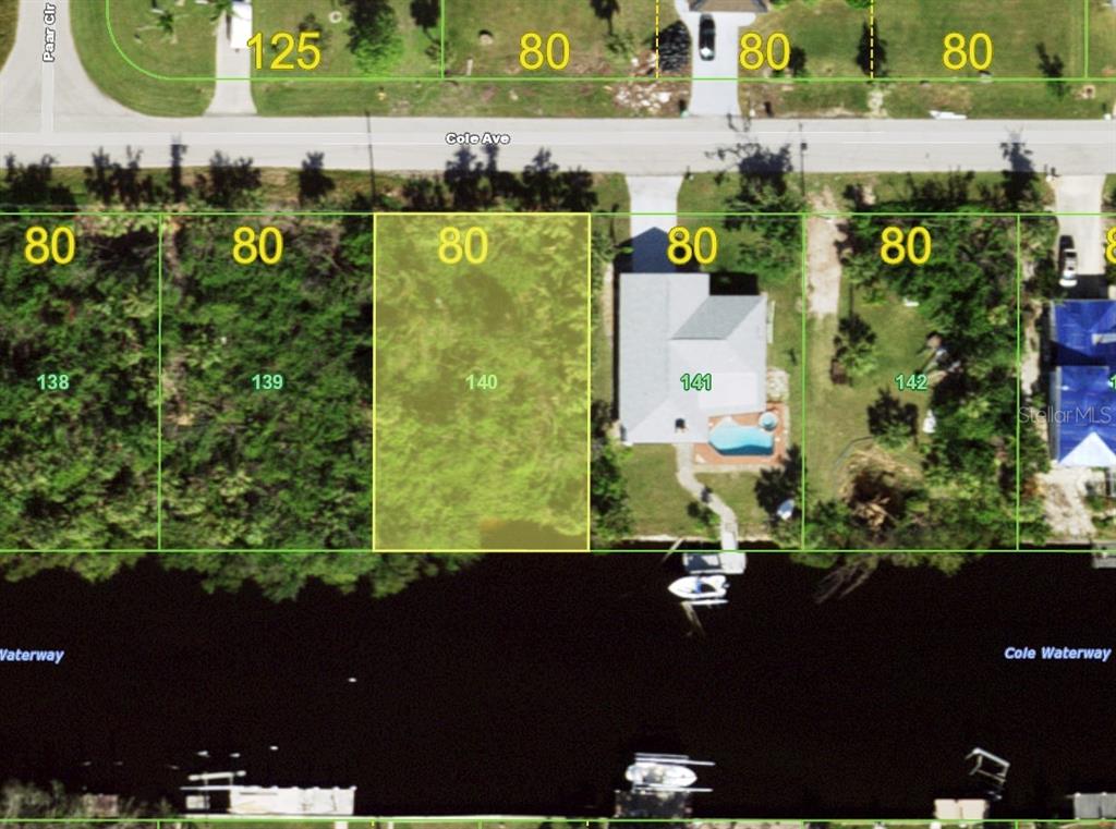 This is an aerial map showing a vacant residential lot highlighted in yellow along a waterway — 12379 COLE AVENUE, PORT CHARLOTTE, FL