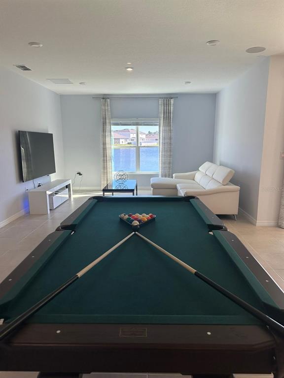A game room features a pool table, a white sectional sofa, and a television — 3921 SOUTHERN VISTA LOOP, ST CLOUD, FL