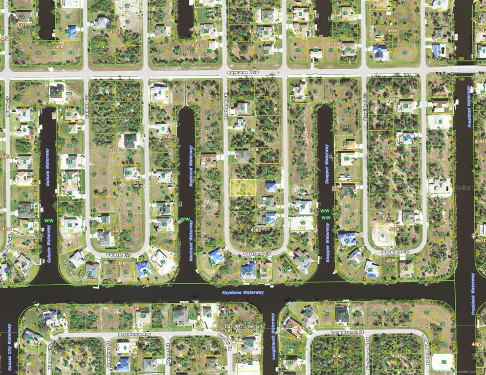 This is an aerial map showing residential lots and waterways in a suburban neighborhood — 9629 NASTRAND CIRCLE, PORT CHARLOTTE, FL