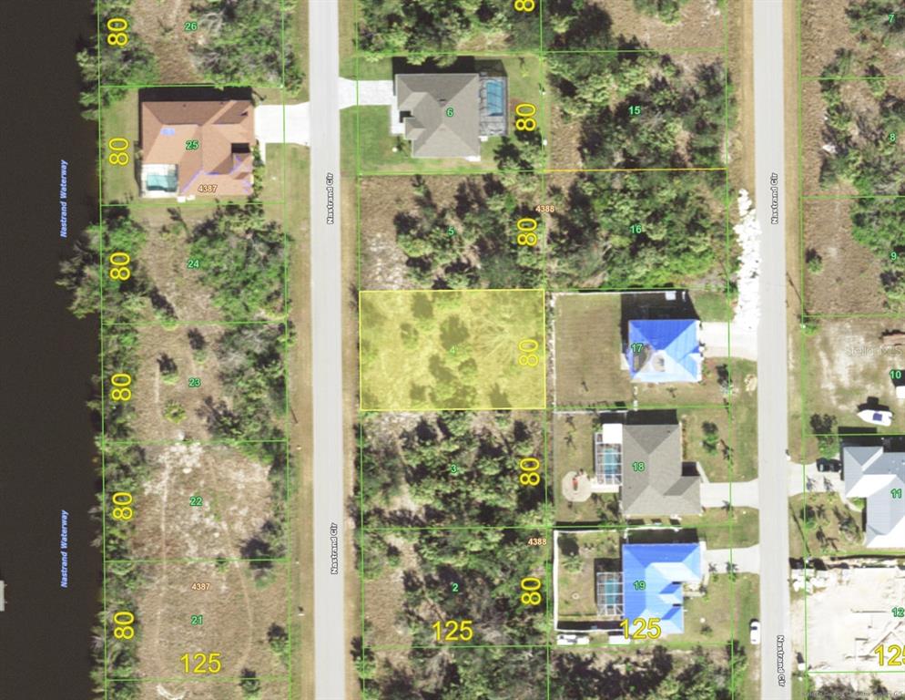 This is a satellite map view showing a vacant, rectangular residential lot highlighted in yellow — 9629 NASTRAND CIRCLE, PORT CHARLOTTE, FL