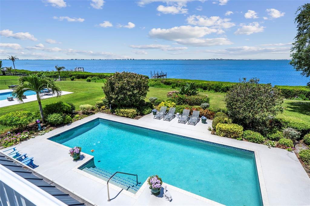 An elevated view of a swimming pool overlooking a large body of water — 8152 LONGBAY BOULEVARD, SARASOTA, FL