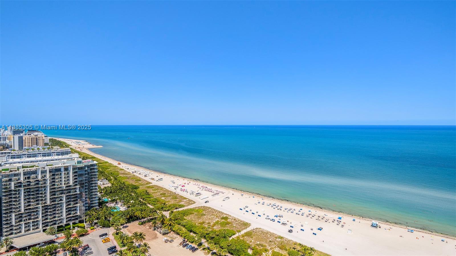 An aerial view shows a sandy beach along the ocean next to high-rise buildings — 101 20th St # 3903, Miami Beach FL 33139, MIAMI BEACH, FL