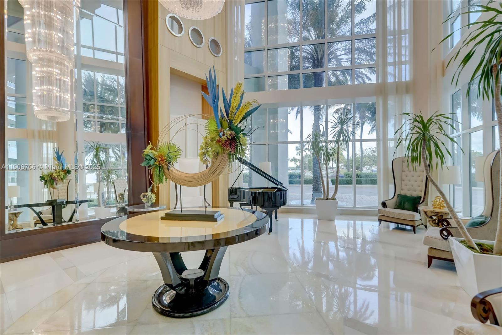 A grand lobby features a circular table, a grand piano, and floor-to-ceiling windows — 1 N Ocean Blvd # 1411, Pompano Beach FL 33062, POMPANO BEACH, FL
