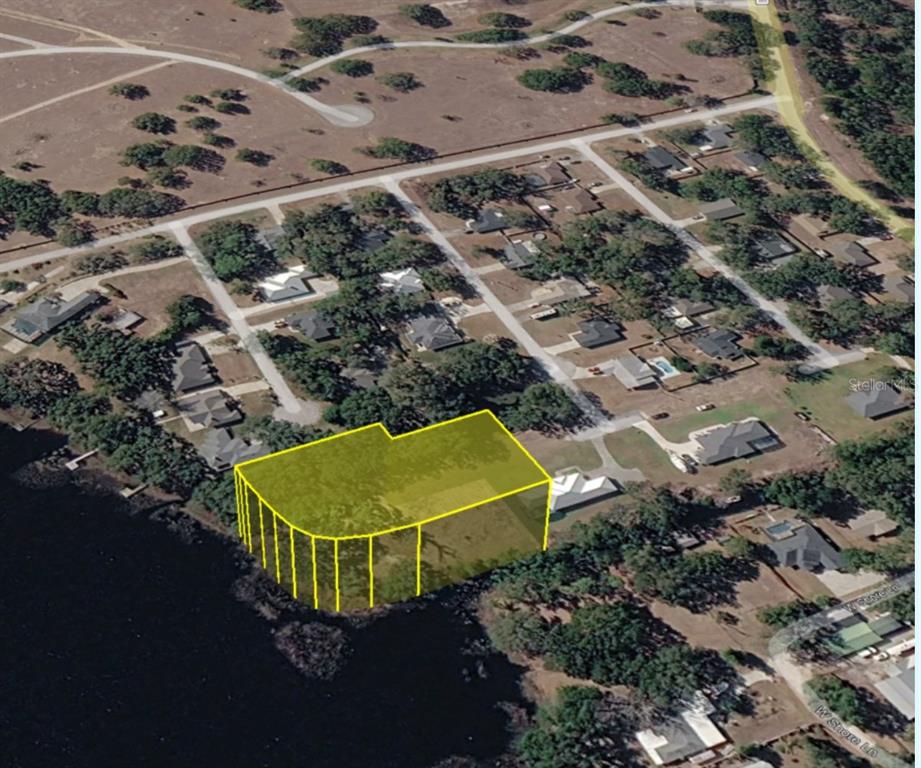 An aerial view shows a waterfront residential lot highlighted in yellow — 0 MIDDLE STREET, GROVELAND, FL