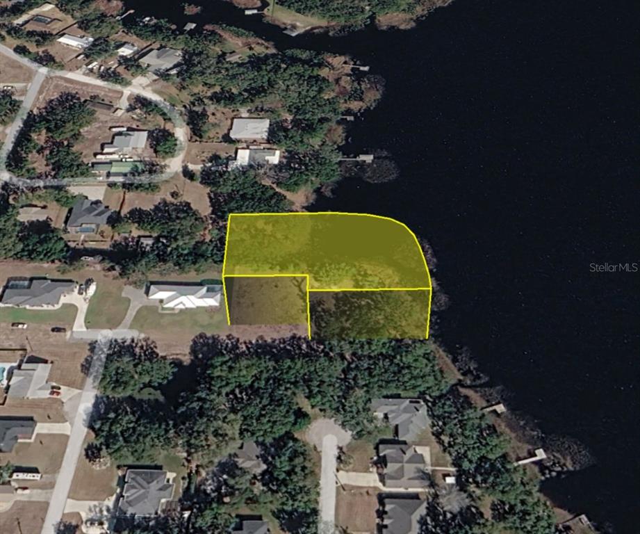 An aerial view shows a highlighted waterfront residential lot with surrounding houses and trees — 0 MIDDLE STREET, GROVELAND, FL