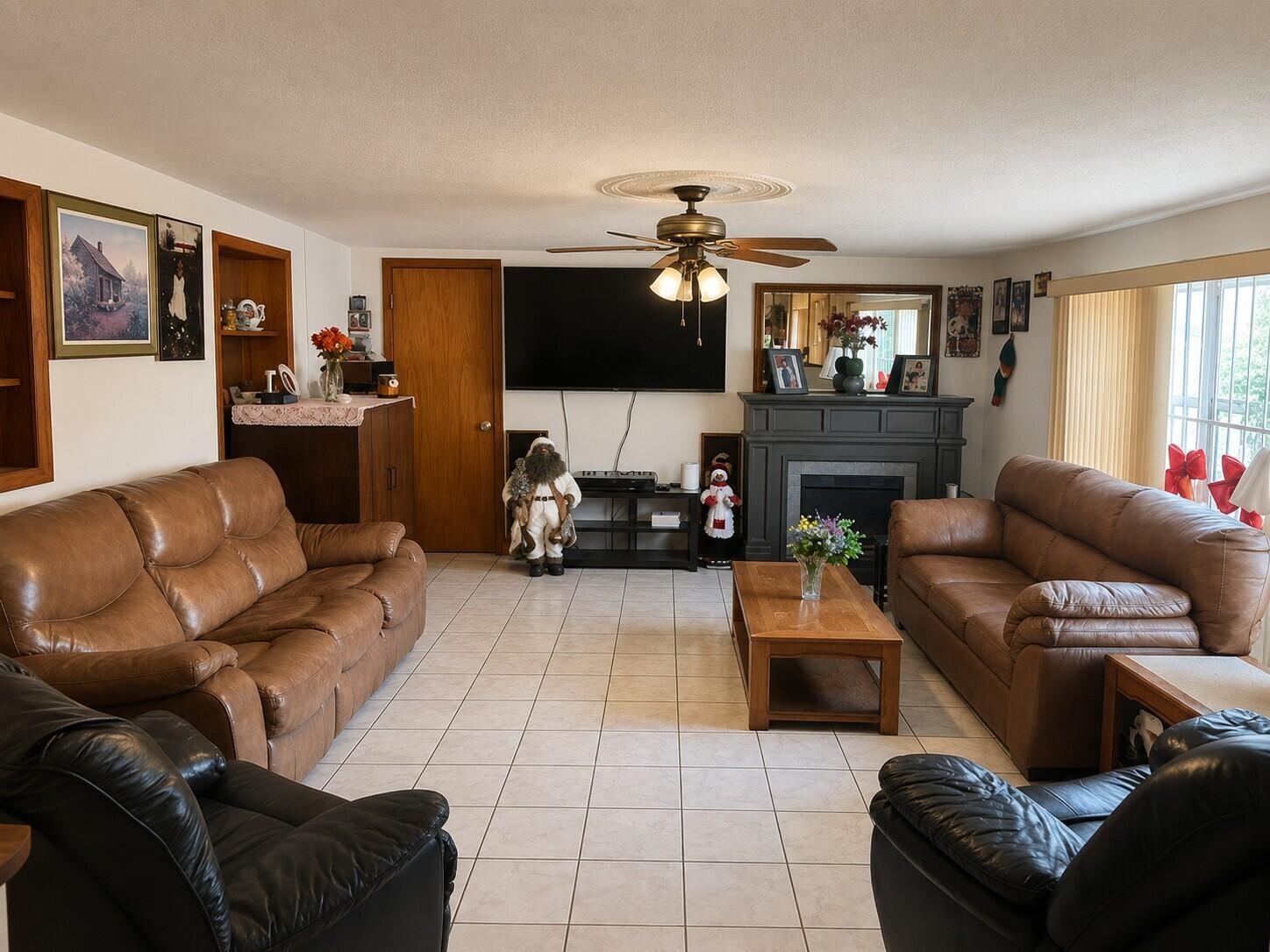 A living room features two brown leather sofas, two black recliners, and a fireplace — 14620 E Polk Street, Miami FL 33176, MIAMI, FL