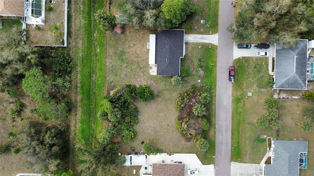 An aerial view shows a residential property with a house, driveway, and surrounding yard — WATOVA AVENUE, NORTH PORT, FL