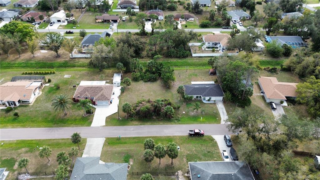 An aerial view shows several suburban houses with driveways and lawns in a residential neighborhood — WATOVA AVENUE, NORTH PORT, FL