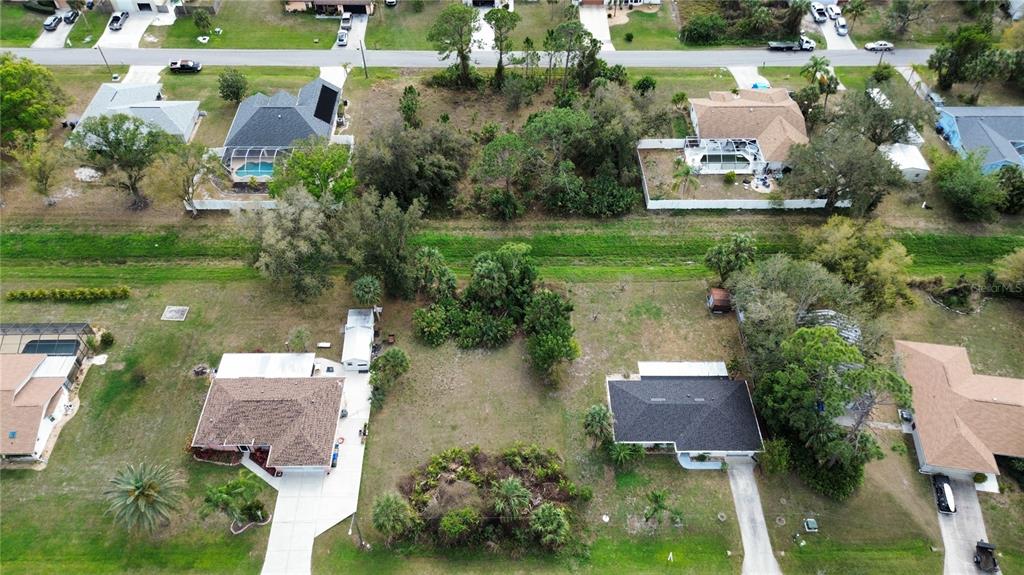 An aerial view shows several residential houses with driveways and yards in a suburban neighborhood — WATOVA AVENUE, NORTH PORT, FL