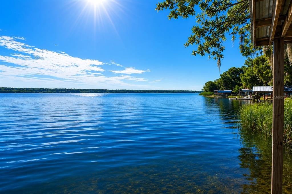 A view of a calm lake with a wooden dock structure on the right side — 4136 CR 400, LAKE PANASOFFKEE, FL